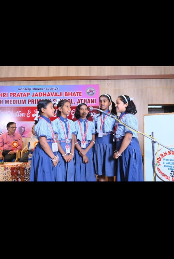 Girls singing at prize distribution